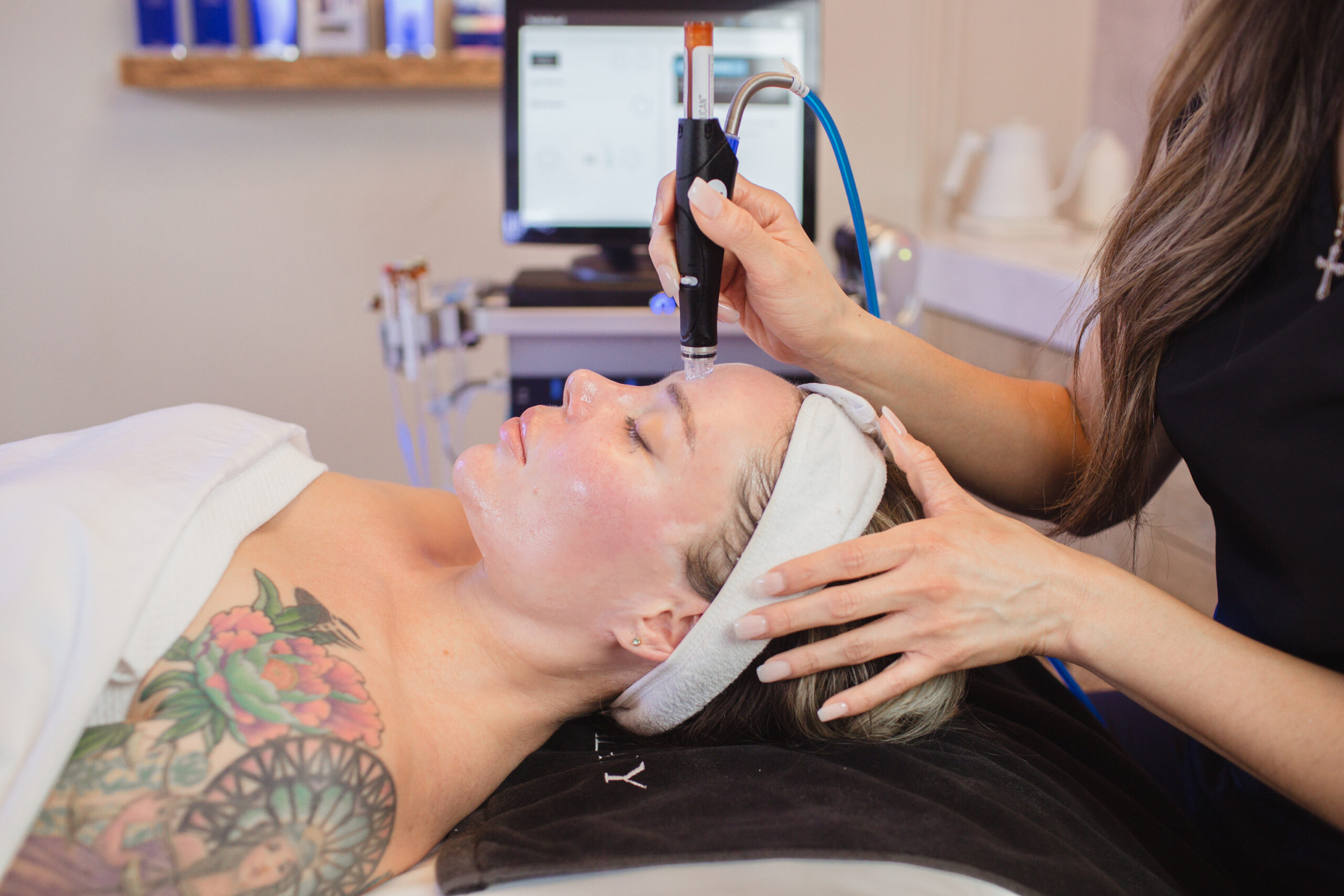 Professional HydraFacial device in use during a skin rejuvenation treatment.