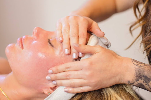 Woman receiving a relaxing HydraFacial treatment with a glowing skin effect.