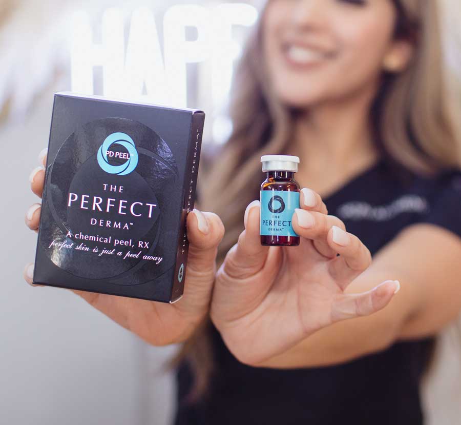 Aesthetician holding up the Perfect Derma Peel box and vial.